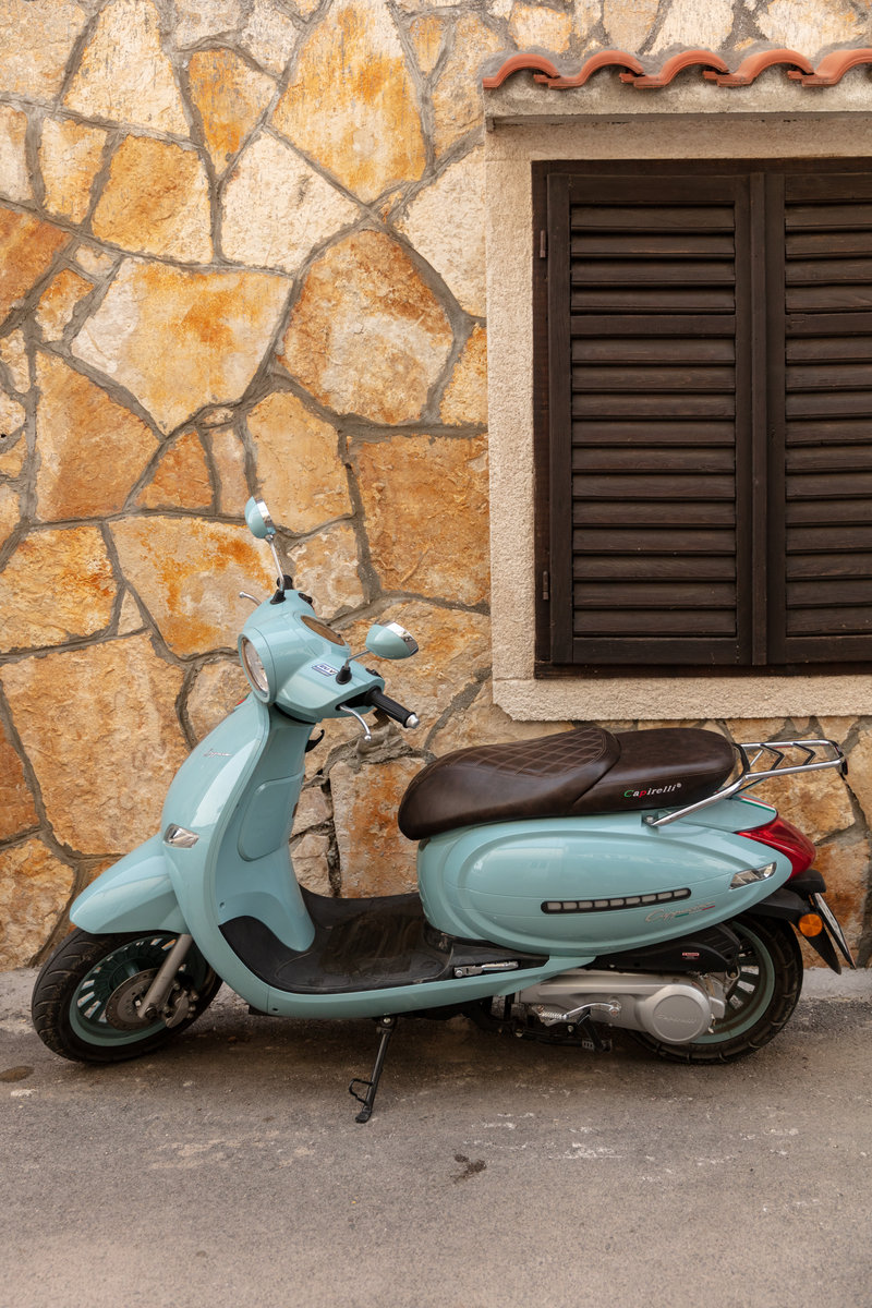 Scooter against a stone facade